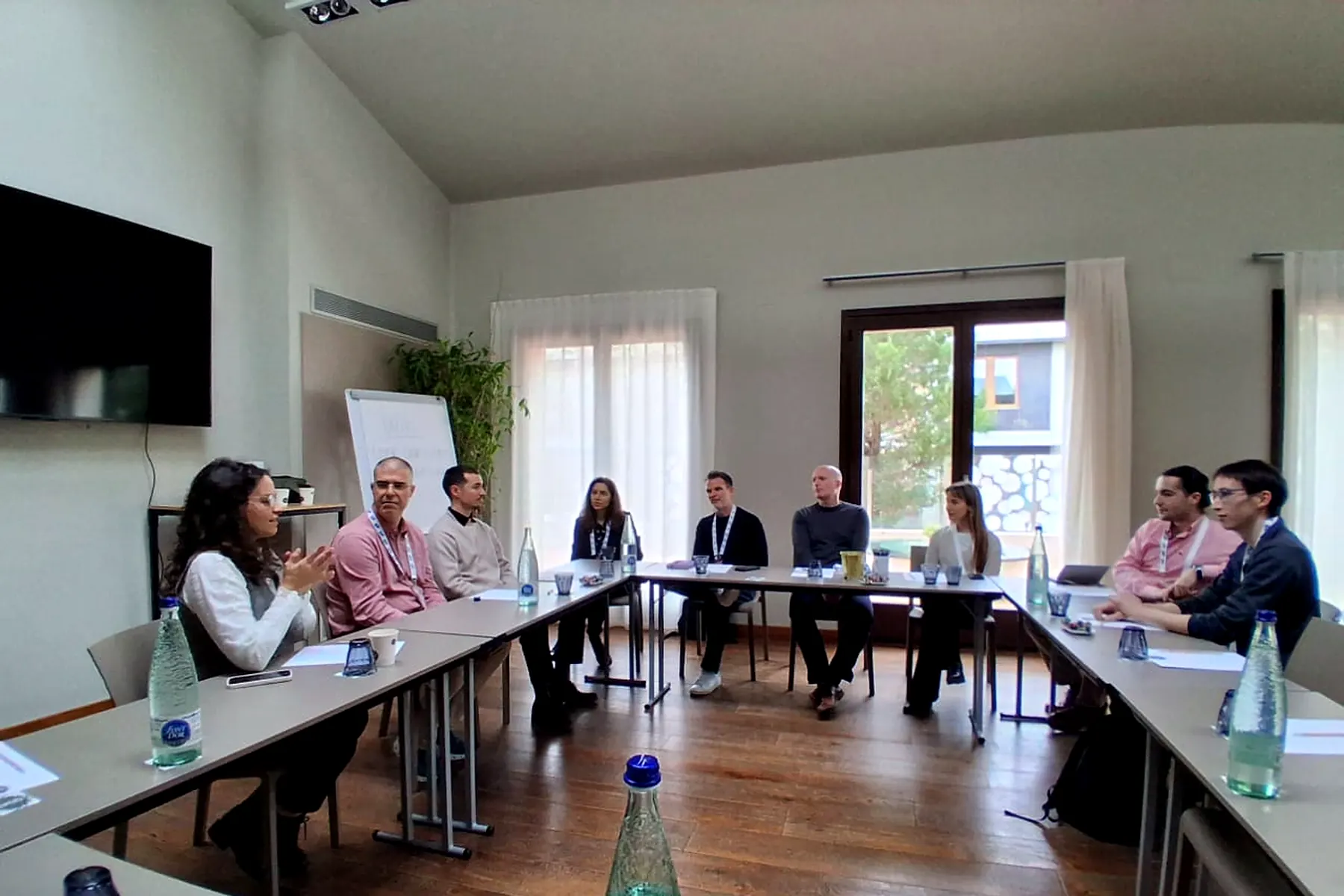 A YEBN career panel seated around a table, in discussion with the audience.