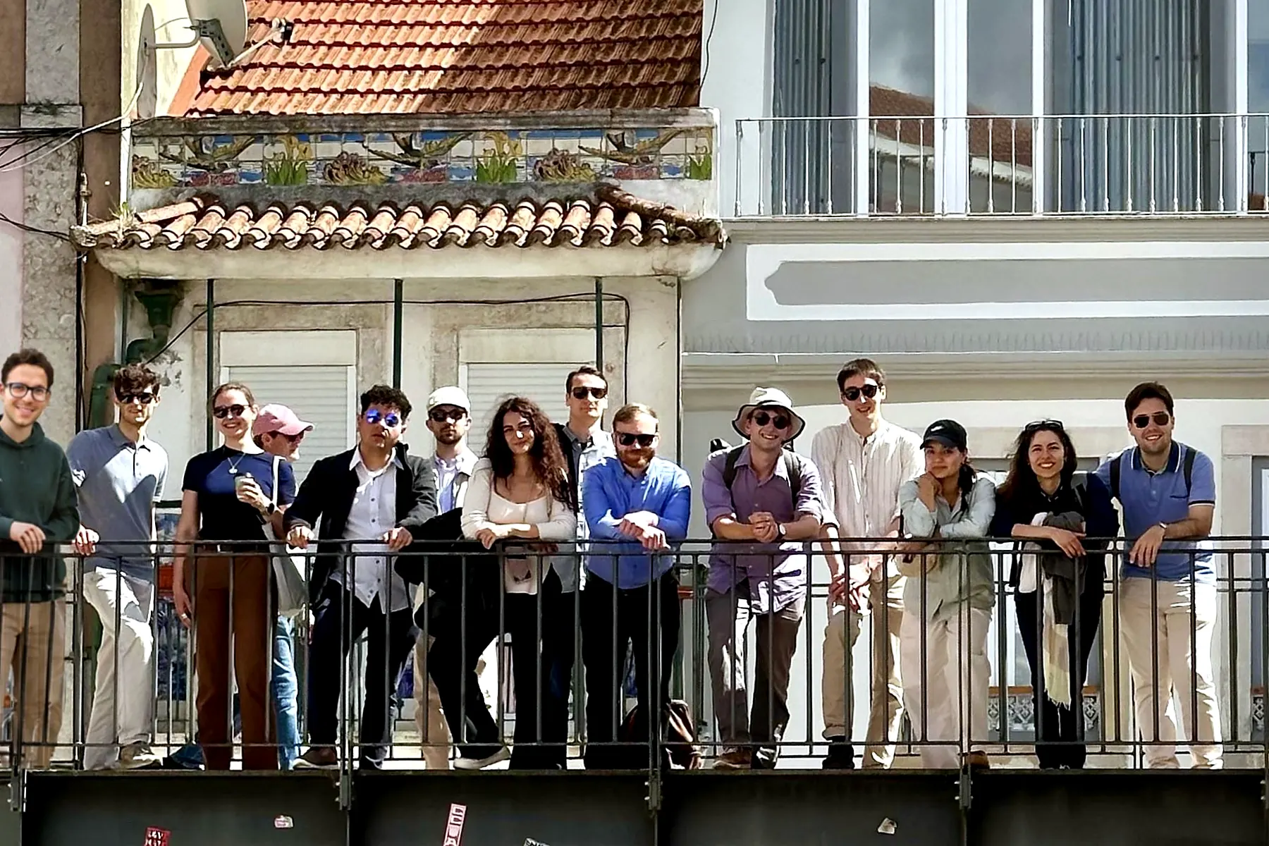 YEBN members on a balcony overlooking a Lisbon street during a social evening.